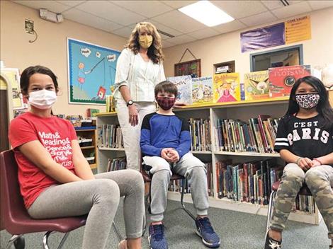 Linderman Librarian Roxanne Hovenkotter stands for a photo with students Abby Pobran, Crosby Goode and  Aiyanna Haynes.