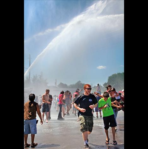 Spectators enjoy a ritual soaking courtesy of the Mission Volunteer Fire Department during the Good Old Days parade.