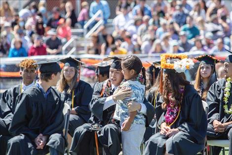 Leonard Burke receives a mid-ceremony hug from a guest.