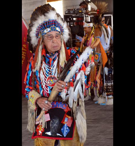 Frances Stanger wears his war bonnet to the Standing Arrow Powwow in Elmo.