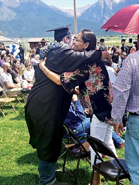 Mission High School graduates give “thank you” roses to  people who helped them achieve success before receiving  diplomas.  