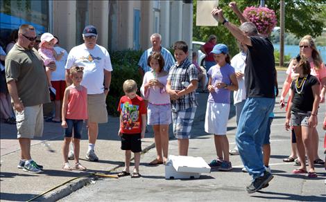 Ken Avison reacts after a contestant spits a pit just a few inches.