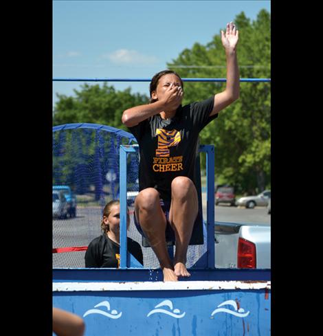 Polson High School cheerleader Cassie Carlyle gets dunked in water, all part of a fun fundraiser for the cheer squad.