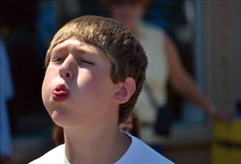 Contestant Daniel Wisekittel puckers up as he prepares to spit a cherry pit.