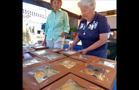 Marie Mitchell and Yvonne Rehard of the Yellow Bay Ladies’ Auxiliary sell pies, muffins and chocolate cherries.