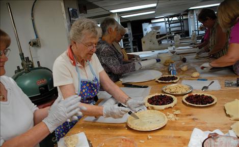 Ladies from the Montecahto Club laugh and visit as they make “sweetart” cherry pies. The sweetart filling is a mixture of sweet and sour Flathead cherries. Baked fresh, the pies were a big hit at the Polson Main Street Flathead Cherry Festival last weekend.