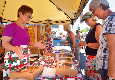 Montecahto members Marlene Mimms, left, and Myrna Ducharme sell cherry pies at the Polson Main Street Flathead Cherry Festival on July 20.