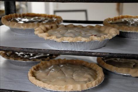 Pies ready to be baked go to a staging area by the oven.