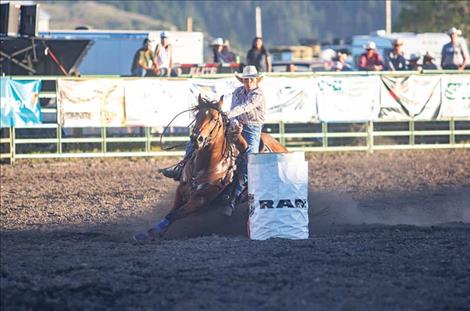 Barrel racer Greta Gustafson makes the turn on barrel two.