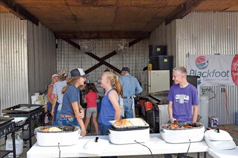 Volunteers serve a pancake breakfast and sides at the fly-in.