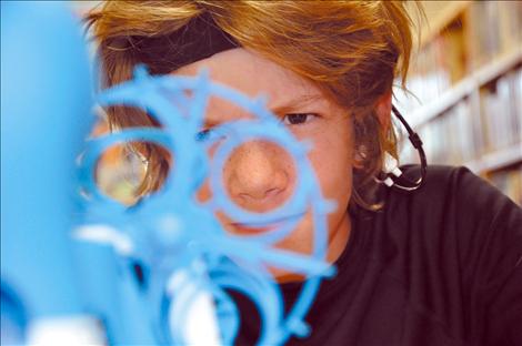 Kyran Kenison concentrates during a brain wave exercise at a GearUp science camp at Arlee High School.