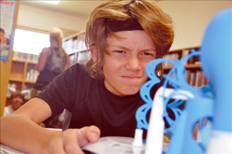 Kyran Kenison concentrates during a brain wave exercise at a GearUp science camp at Arlee High School. 