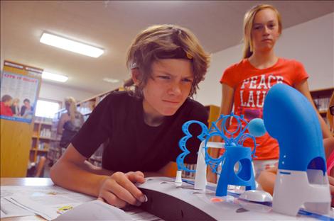 Kyran Kenison concentrates during a brain wave exercise at a GearUp science camp at Arlee High School.
