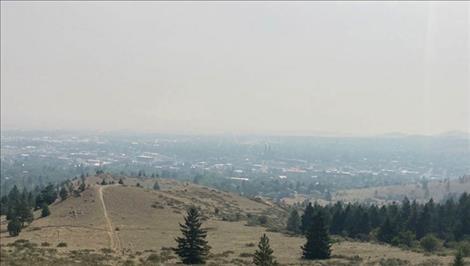 Smoke from wildfires burning through dry forests and grasslands in the West covered the city of Helena on Sunday, July 18, 2021. 