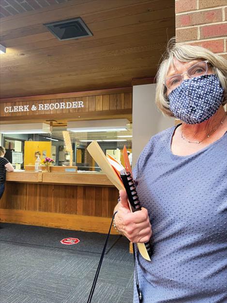 Janette Rosman takes irrigation assessment documents to the Lake County Clerk and Recorder, although county officials have written a resolution of intent to end the  collection of irrigation fees. 