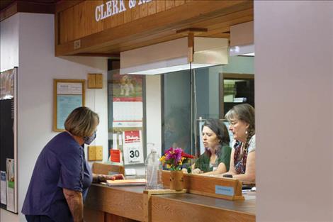 Flathead Irrigation District Commissioner Janette Rosman submits irrigator assessment paperwork to the Lake County Clerk and Recorder’s Office. 