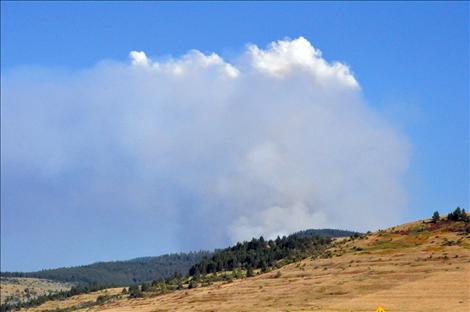 A plume of smoke rises Saturday afternoon as winds fanned the flames.