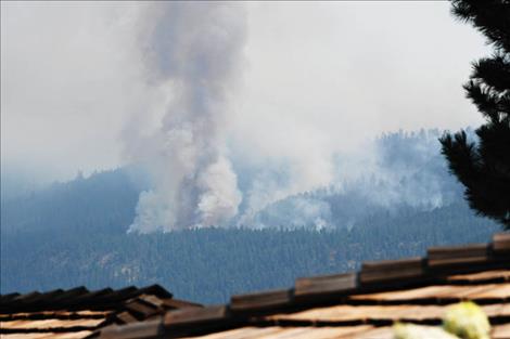 The Boulder 2700 fire as seen above the roof of a home near Finley Point on Saturday, July 31.