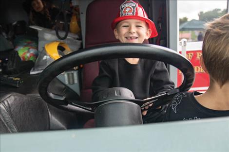 A youngster is all smiles behind the wheel of a fire truck during Saturday’s Day of Hope event.