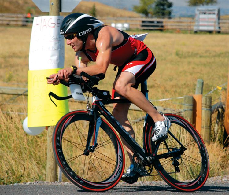 A cyclist races through miles of farmland along Eli Gap Road, southwest of Polson.