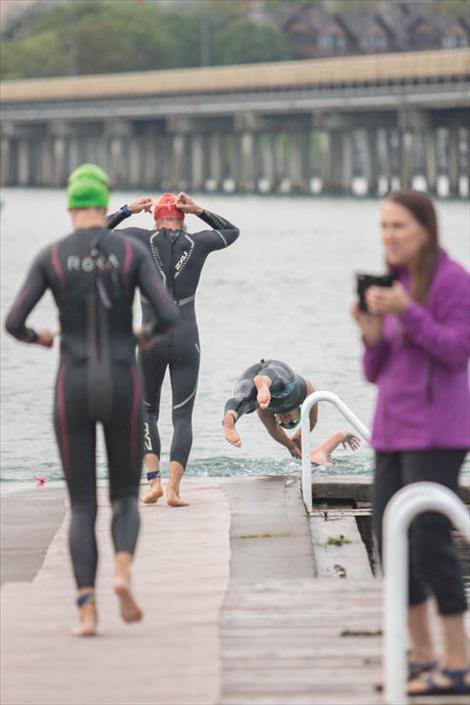 Swimmers make their way into the brisk waters of Flathead Lake.