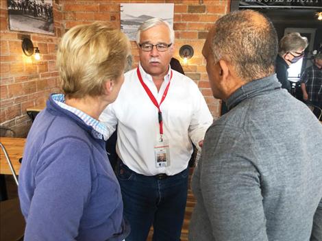 County commissioner Bill Barron discusses housing challenges with State  Representative Linda Reksten and Polson city planner Juan Escano. 