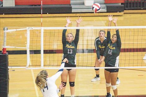 Polson Lady Pirates battle at the net during the Western A volleyball tip-off tournament.