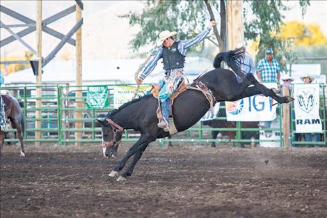 Kolby Kittson of Browning puts on a show with an 80-point ride during the Flathead River Rodeo