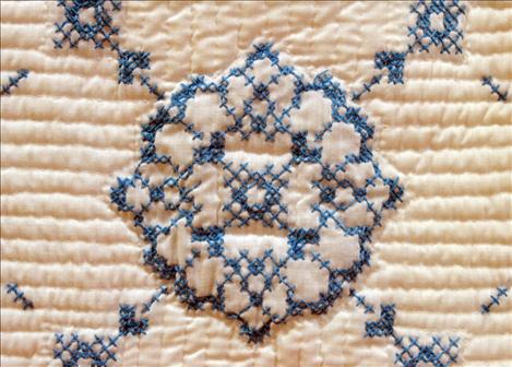 A cross-stitched block from “Amy’s Quilt” reveals the detail and dedication in the hand-stitched prize winner.