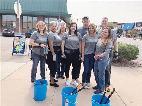 pril McLain, Randi Horner, Donna  Gebhardt, Liz Johnson, Dave Rensvold,  Michelle Morgan, Shad Hupka and Jenaya Garcia volunteer to clean out street corner flowerbed bumpouts in downtown Polson on Sept. 8.