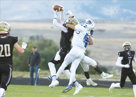 Polson Pirate wide receiver Colton Graham snags a pass over Wildcat defenders.