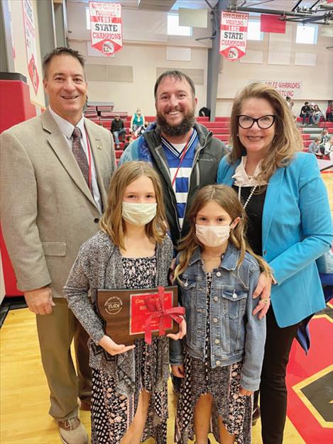 Arlee High School science teacher Bill Stockton poses for a photo after being honored as Montana Teacher of the Year. Pictured from left are: Arlee School Superintendent Mike Perry, Bill Stockton, Montana State Superintendent Elsie Arntzen and (front) Bill’s daughters Norah and Brooklyn Stockton.