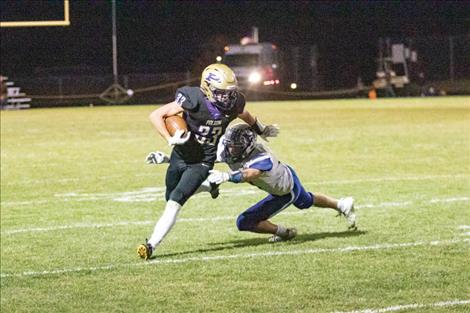 Polson Pirate running back Keyen Nash slips past a defender for a first down.