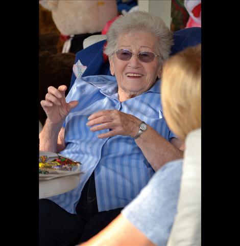 Marie Cowen visits with a friend at her bear sale Saturday, Aug. 10.