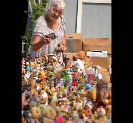 A shopper peruses a table stuffed with ceramic versions of the beloved bears.