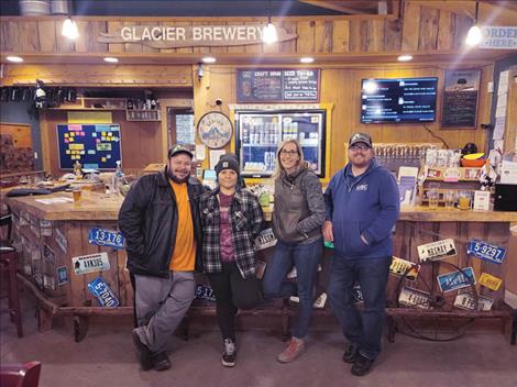 Good Grub Food Truck owners Clay Butte and Anisha Algarin, Mission Mountain Enterprises Executive Director Lauren Oliver and Glacier Brewing Company owner Patrick May smile for a photo during the Oct. 14 community inclusion fundraiser.