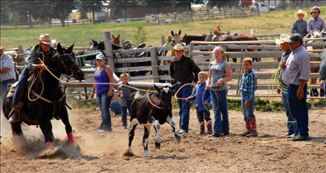 Levi McClure, Ronan, ropes his breakaway calf as his horse puts on the brakes.