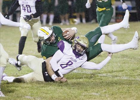 Polson Pirate Jarrett Wilson tackles a Whitefish Bulldog runner.