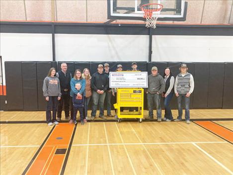 Casey Lunceford, second from left, poses with his students after being given a personalized tool cart and a check for $50,000 from Harbor Freight Tools For Schools.