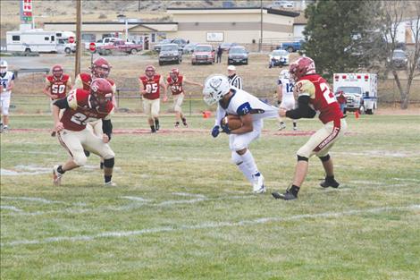 Mission Bulldog Kenny Ness tries to break free of a defenders grasp. 