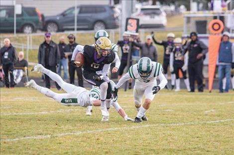 Pirate Colton Graham slips past diving  Ram defenders.