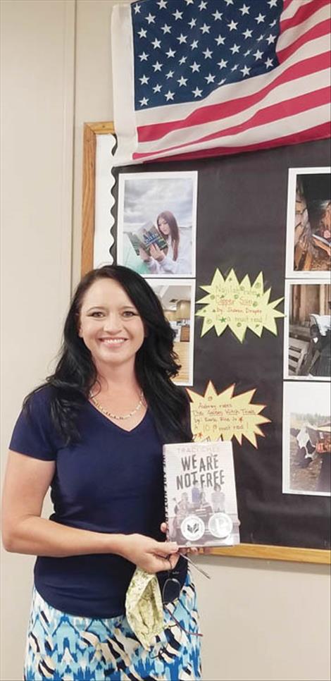 Polson High School social studies teacher Katrina Holmes holds the book “We Are Not Free” that she bought for her classroom through a grant awarded by the Kuilix Chapter of the Daughters of the American Revolution.