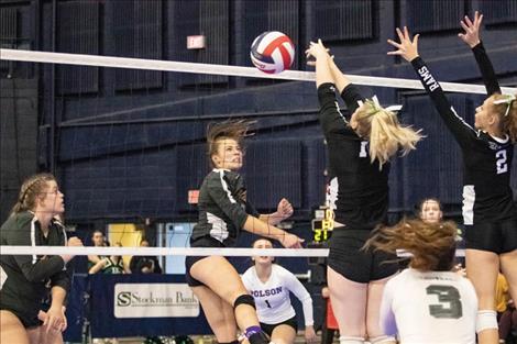 Polson Lady Pirate Liz Tolley powers the volleyball past Ram defenders.