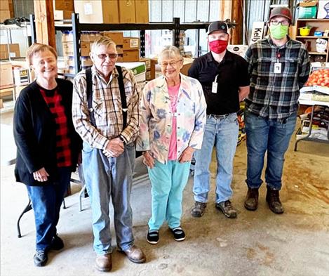 Volunteers from Ronan’s Bread Basket food pantry pose for a photo with St. Luke Community Healthcare staff after receiving a donation of food and money from St. Luke’s holiday food drive. Polson and St. Ignatius food pantries also received drive donations.