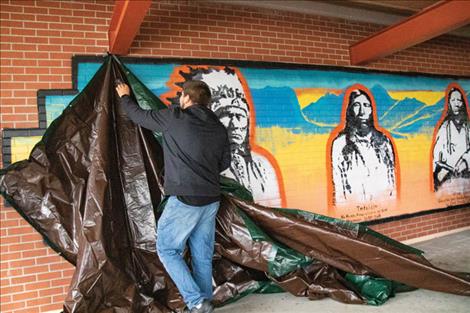Local artist Cameron Decker unveils the mural he recently finished of historic chiefs of the Kootenai, Salish and Pend d’Oreille nations – Chief Koostatah, Chief Charlo and Chief Alexander.