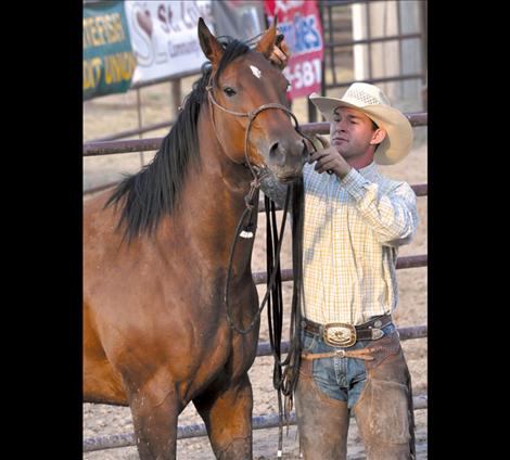 Levi Walchuk bridles his horse at the roundpen shootout.