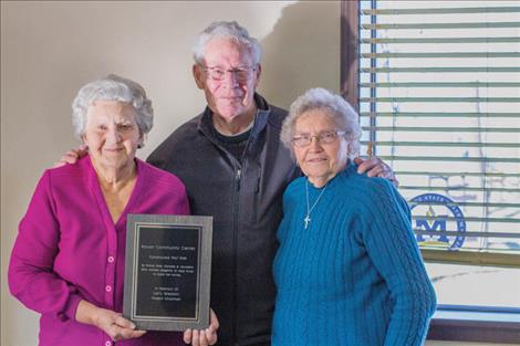 Alice Gleason, Al and Joan Sampson pose for a photo with plaque honoring Jaycees and Jayceens who developed and built the Community Center in Ronan.