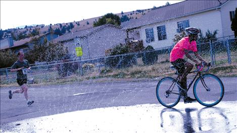 Thomas Sanburg cruises through a refreshing sprinkling of water.