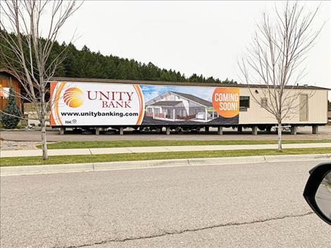Unity Bank in Polson is now located off of Ridgewater Drive in a “Banking Bungalow” while their new office, a sketch of which is featured on the side of the temporary building above, is being built.