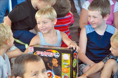 Lucas Johnson wins a Beyblades toy after entering 18 tickets earned by participating in the summer reading program at Ronan Library.